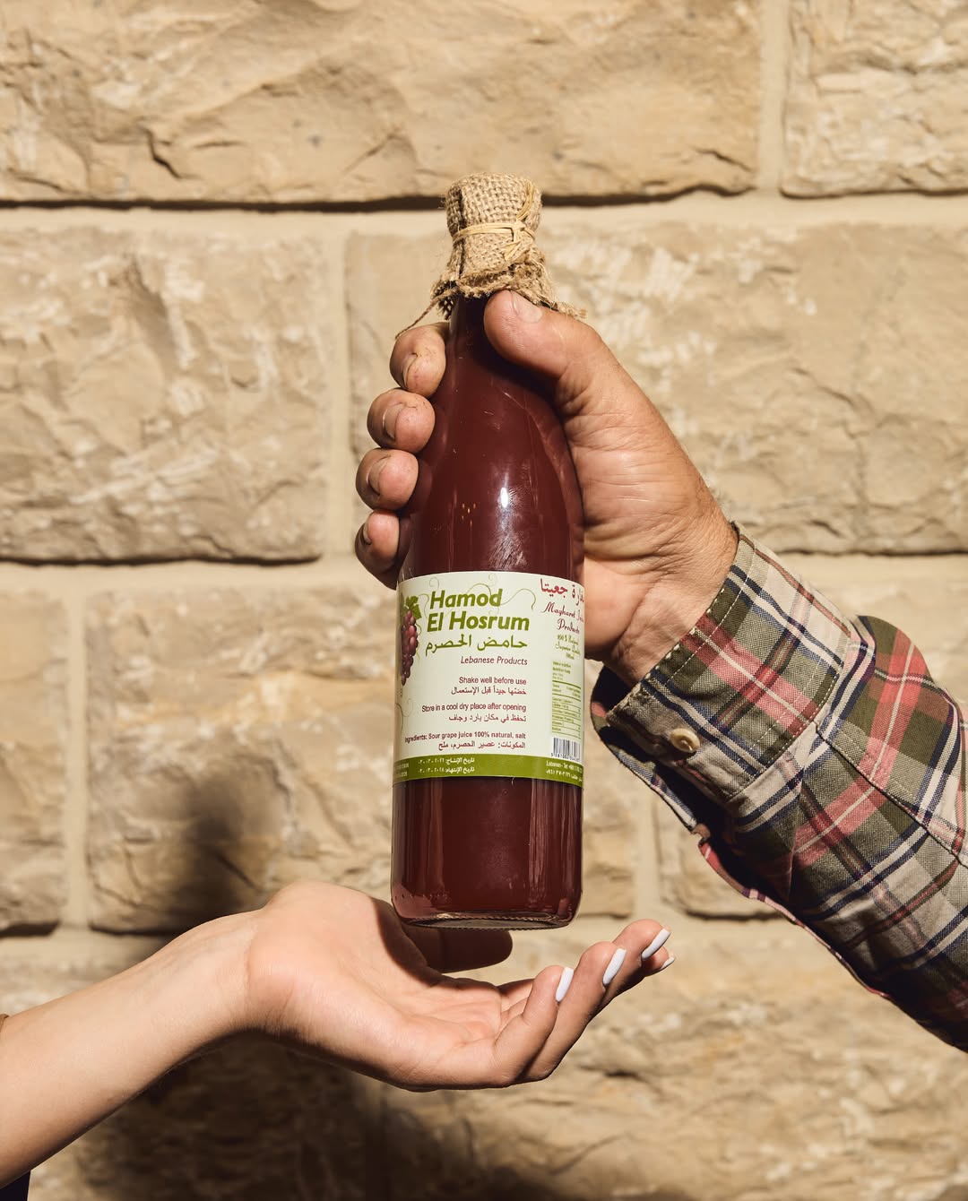 Farmer hands passing bottle